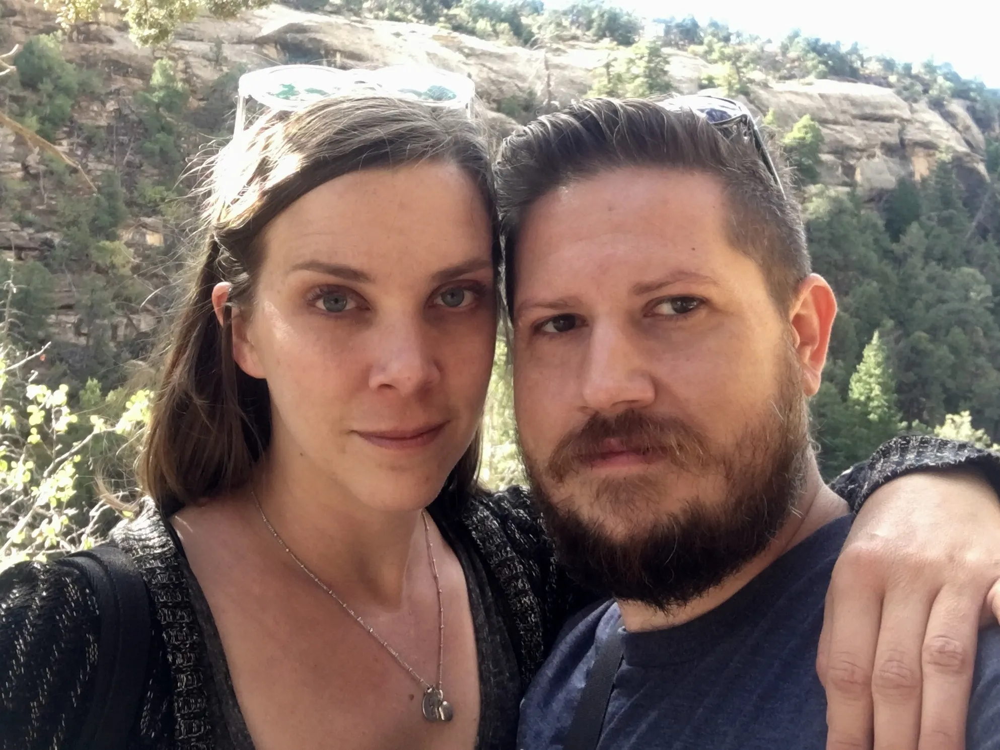 Us on a canyon trail with pines and sandstone behind