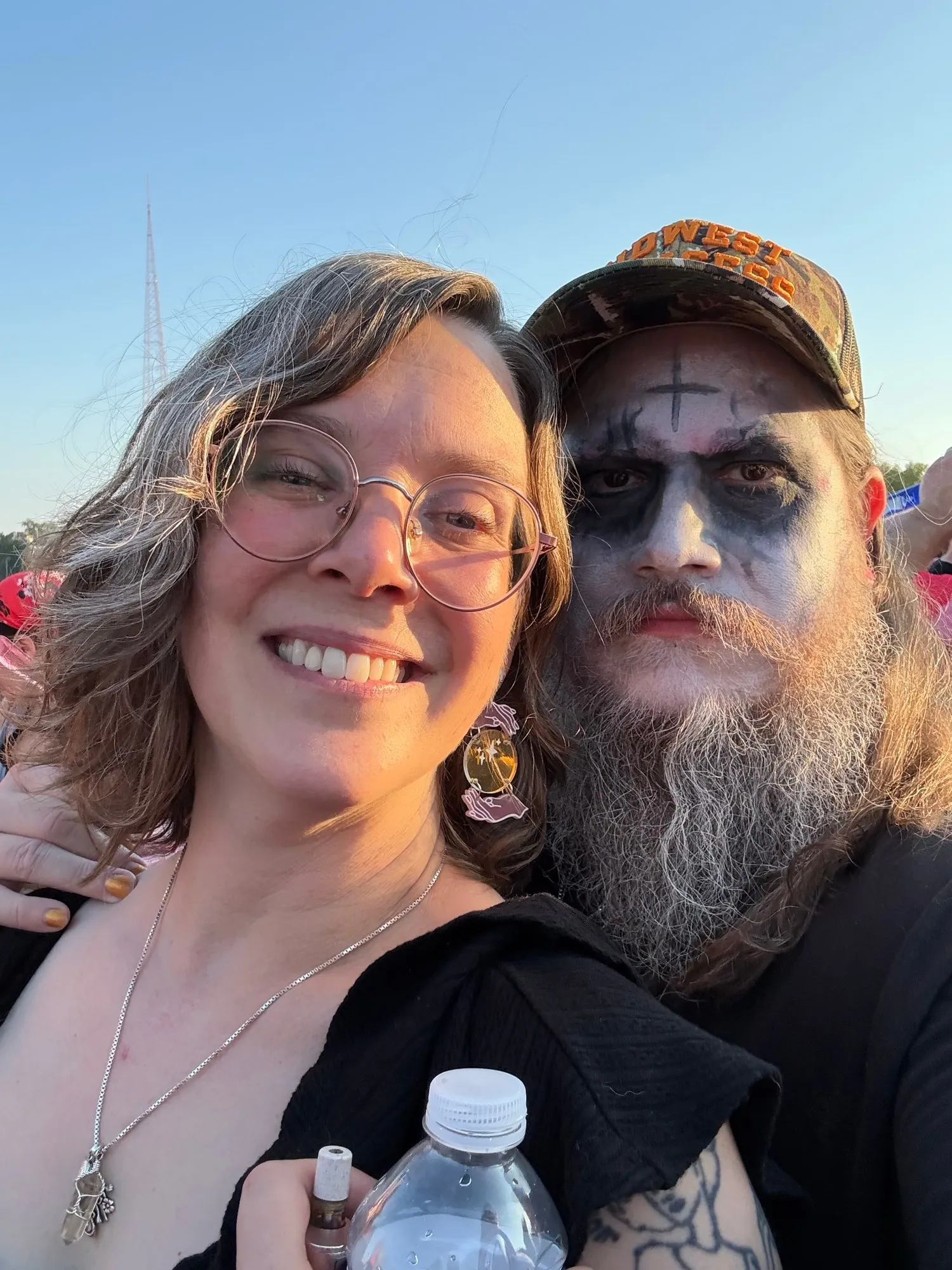 Us at an outdoor festival, one of us in black and white face paint
