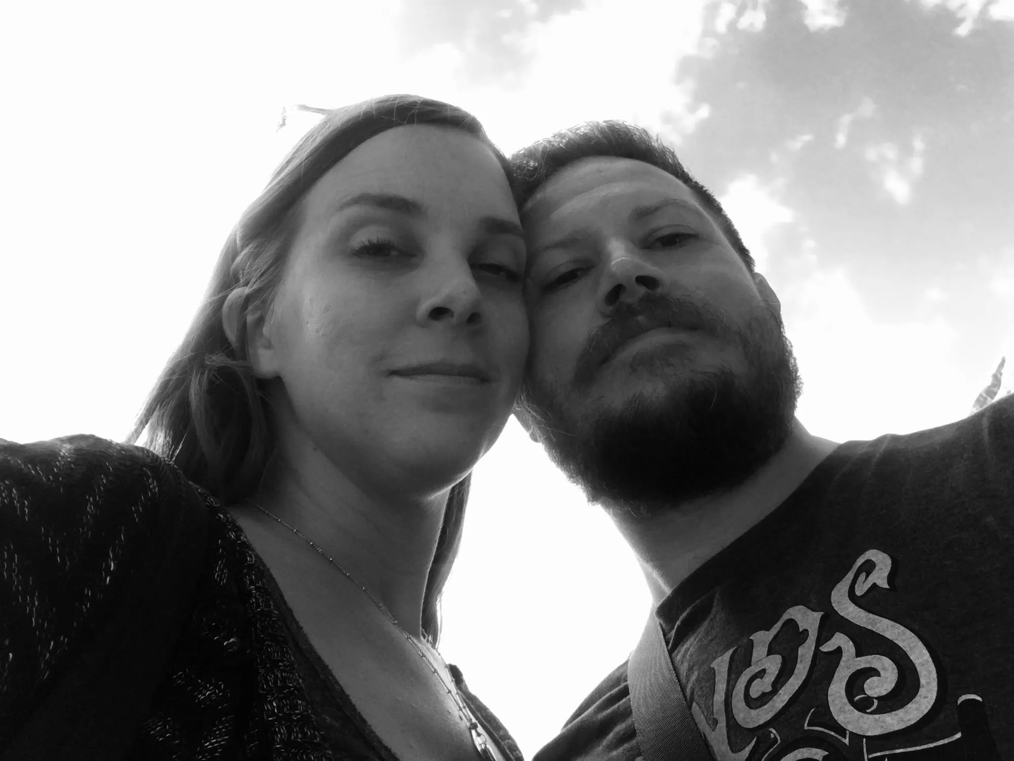 A black and white selfie of us under a bright sky